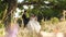 Man in business suit and woman in white wedding dress are happy riding on swing. Bride and groom in love are resting in
