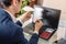 Man businessman holding a paper airplane origami in his hands. Concept of purchasing and booking airline tickets online