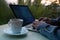 Man, businessman, programmer, working in the evening at a laptop on the balcony of his house, hands closeup, concept of remote