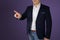 Man, businessman, stands, shows a finger, business concept, close-up, copy space, dark purple background