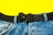 A man buttoned a black cloth belt on jeans. Modern men`s waistband with dark matted metal buckle