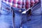 Man is buttoning his jeans and buckling his belt wearing, hands closeup.
