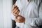 Man buttons shirt, a man in a white shirt, hands of a man close-up, businessman puts on a suit