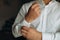 Man buttons shirt, a man in a white shirt, morning groom, hands of a man close-up, a white shirt on a businessman, man