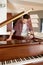 Man buyer looking on tuning keys inside grand piano under lid