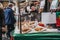 Man buying cakes and pies from a market stall at Greenwich Market, London, UK