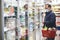 Man buying food in grocery store, wearing medical mask