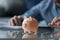 Man calculates expenses, piggybank and coins on foreground