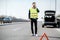 Man calling road assistance on the highway