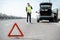 Man calling road assistance on the highway