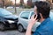 Man calling roadside emergency after car accident