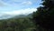 Man with camera descends into valley between mountains in area Baturiti Bedugul, Baturiti, Kec. Baturiti, Kabupaten Tabanan, Bali