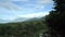 Man with camera descends into valley between mountains in area Baturiti Bedugul, Baturiti, Kec. Baturiti, Kabupaten Tabanan, Bali