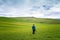 Man with camera among spring hills of Tuscany