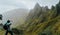 Man with camera taking a foto of gorgeous canyon valley on the path from Xo-Xo Valley. Santo Antao Island, Cape Verde