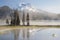 Man on a canoe. Mountains reflect over the calm waters of Sparks Lake at sunrise in the Cascades Range in Central Oregon, USA