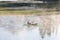 Man on a canoe. Mountains reflect over the calm waters of Sparks Lake at sunrise in the Cascades Range in Central Oregon, USA