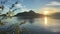 A man on a canoe sailing far Porteau Cove Provincial Park Canada Vancouver As the sun is seen as the sun sets behind the