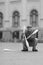 A man in a cap demonstrates maces in a street