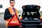 Man with car breakdown erecting warning triangle