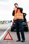 Man with car breakdown erecting warning triangle