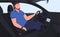 A man in the car interior. Modern comfortable car interior with dashboard and driver seats. Vector illustration