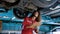 Man car mechanic Caucasian, was inspecting condition car that came into garage with some abnormal car symptoms, keep checkbook on