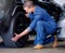 Man, car mechanic and tire change in garage, vehicle maintenance or service. Expert, professional and repairman in
