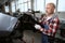 Man in car repair shop disassembles broken car for parts