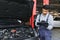 man car technician mechanic repairing car problem of engine, during system checking detail, using tablet computer for