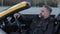 Man in Car, A thoughtful mature man in a leather jacket sitting in a convertible car