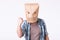 Man with cardboard box on his head and drawing of angry emoticon face. Angry man starting a fight.