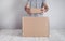 Man with a cardboard box. Products, Commerce, Retail, Delivery