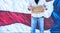 Man with cardboard sign, Out of Work military Veteran, with American Flag,