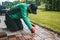 A man carefully installing wooden floorboards on the terrace