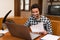 Man caressing his cat while working at home