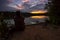 Man carp fishing on a lake watching the sunset