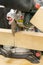 man carpenter cutting wood using table saw at construction site