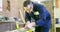 A man carpenter is working with wood using a special machine in a studio.