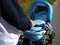 A man carries a blue stroller with a baby inside. Compliance with the regime. Daytime summer walk in cool weather