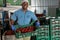 Man is carrying boxes in warehouse