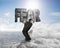 Man carrying fear concrete word on ridge with cloudscape cityscape