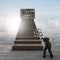 Man carrying key toward treasure chest on wood stairs