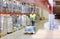 Man carrying loader with goods at warehouse