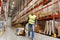 Man carrying loader with goods at warehouse