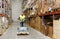 Man carrying loader with goods at warehouse