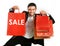 Man carrying red sale shopping bags