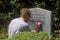 A man carving a gravestone at Kilcatherine Church in Cork, Ireland