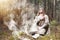 A man in a cassock spends a ritual in a dark forest