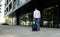 Man in casual clothes walking with a suitcase